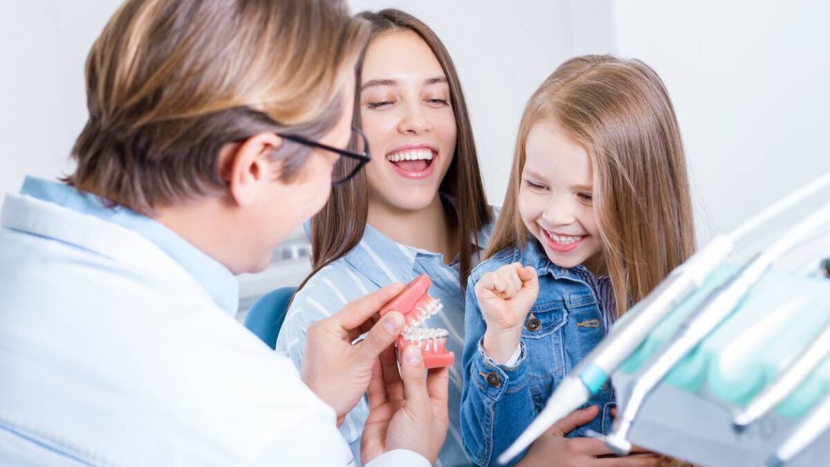 Young mother with daughter at dentist office