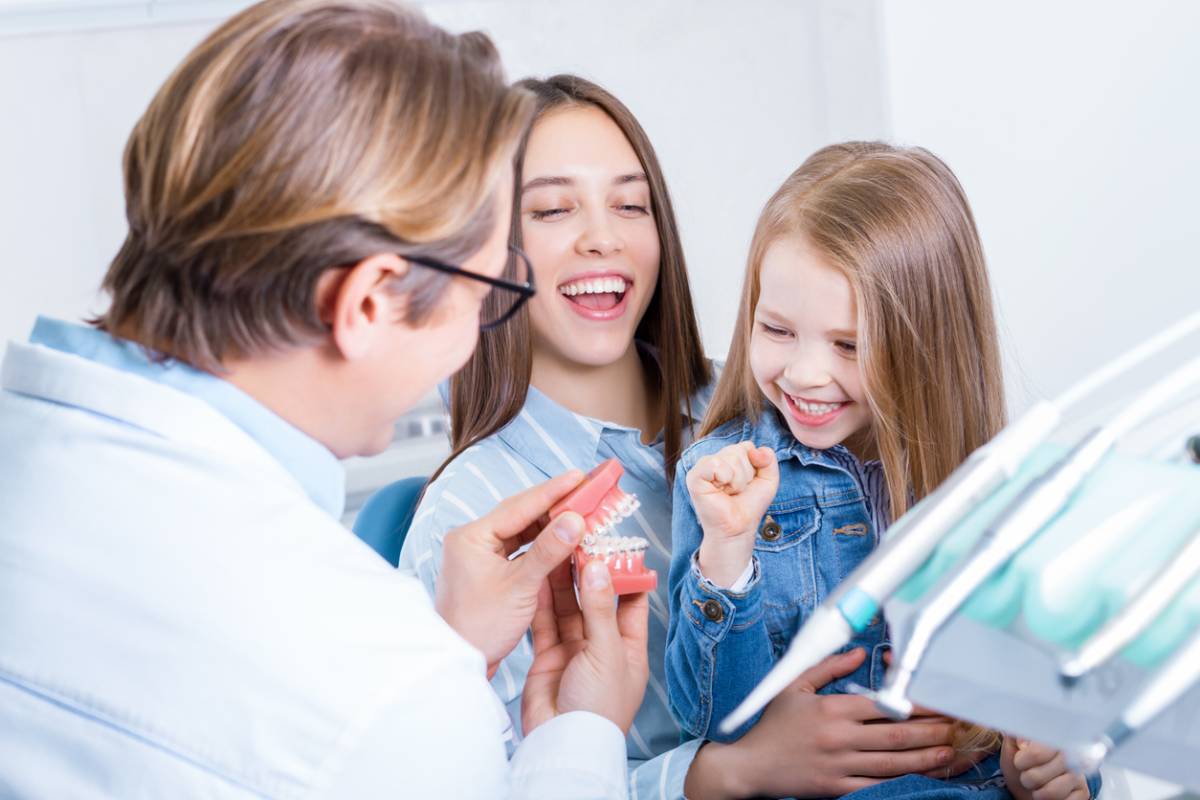 Young mother with daughter at dentist office